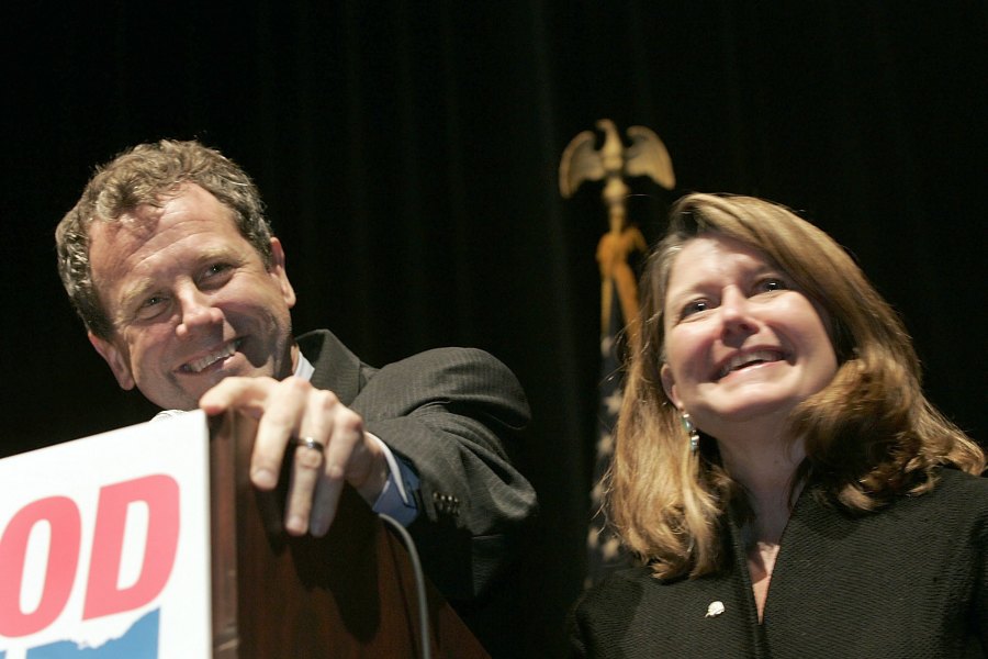 CLEVELAND, OH – NOVEMBER 7: Ohio Democratic Senator-elect Sherrod Brown (L) gives his victory speech with his wife Connie Schultz (R) and his family, friends and staff at the Public Auditorium in the Convention Center on November 7, 2006 in Cleveland, Ohio. Brown defeated incumbent Senator Mike DeWine (R-OH) in the heated election in the state of Ohio. (Photo by Jamie Rose/Getty Images)